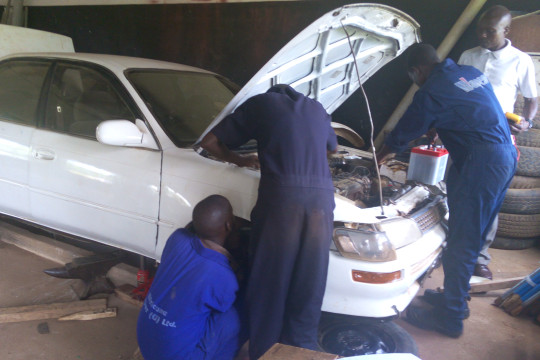 Automotive mechanics students in practical lesson
