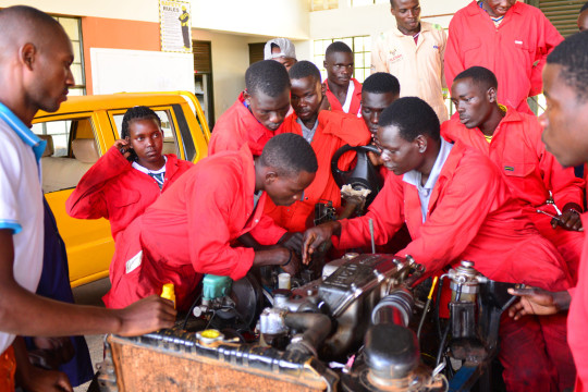 Students studying different parts of a motor-vehicle Engine